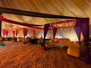 mayoun-wedding-decor colourful mehndi setup, sofa seating, fairy lights decor, multicolored draping