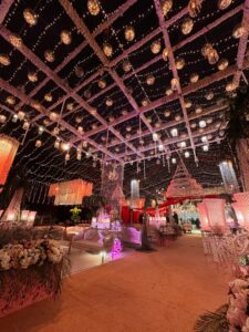 crystal hanging, fairy lights, indoor setup, carpeted walkway