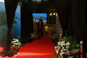 company-event entrance setup, red carpeting, floral decor, corporate meeting