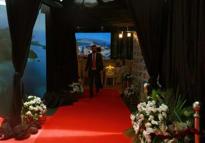 entrance setup, red carpeting, floral decor, corporate meeting