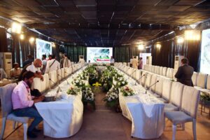 executive-seating meeting setup, floral decor, open air event, events services