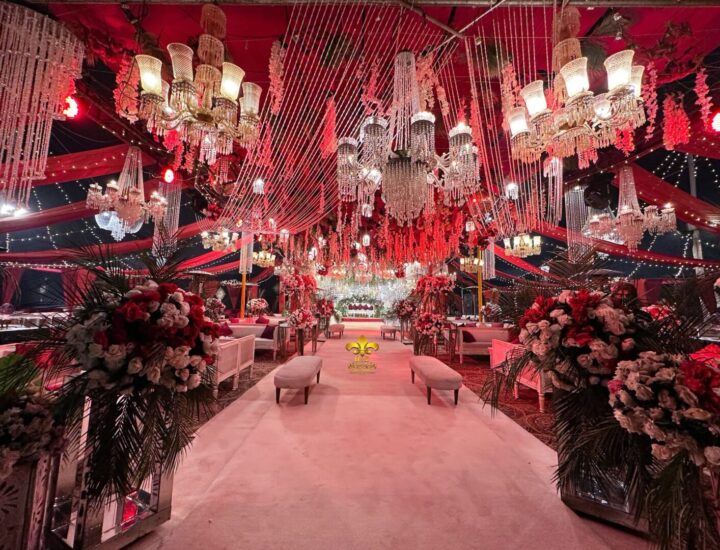 indoor baraat setup, royal red theme, carpeted walkway, floral decor